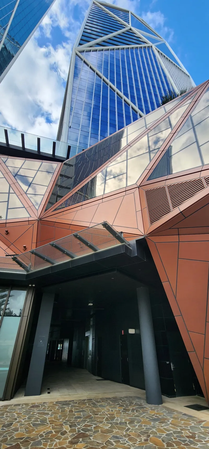The Langham: bronze faceted cladding over the glazed entrance